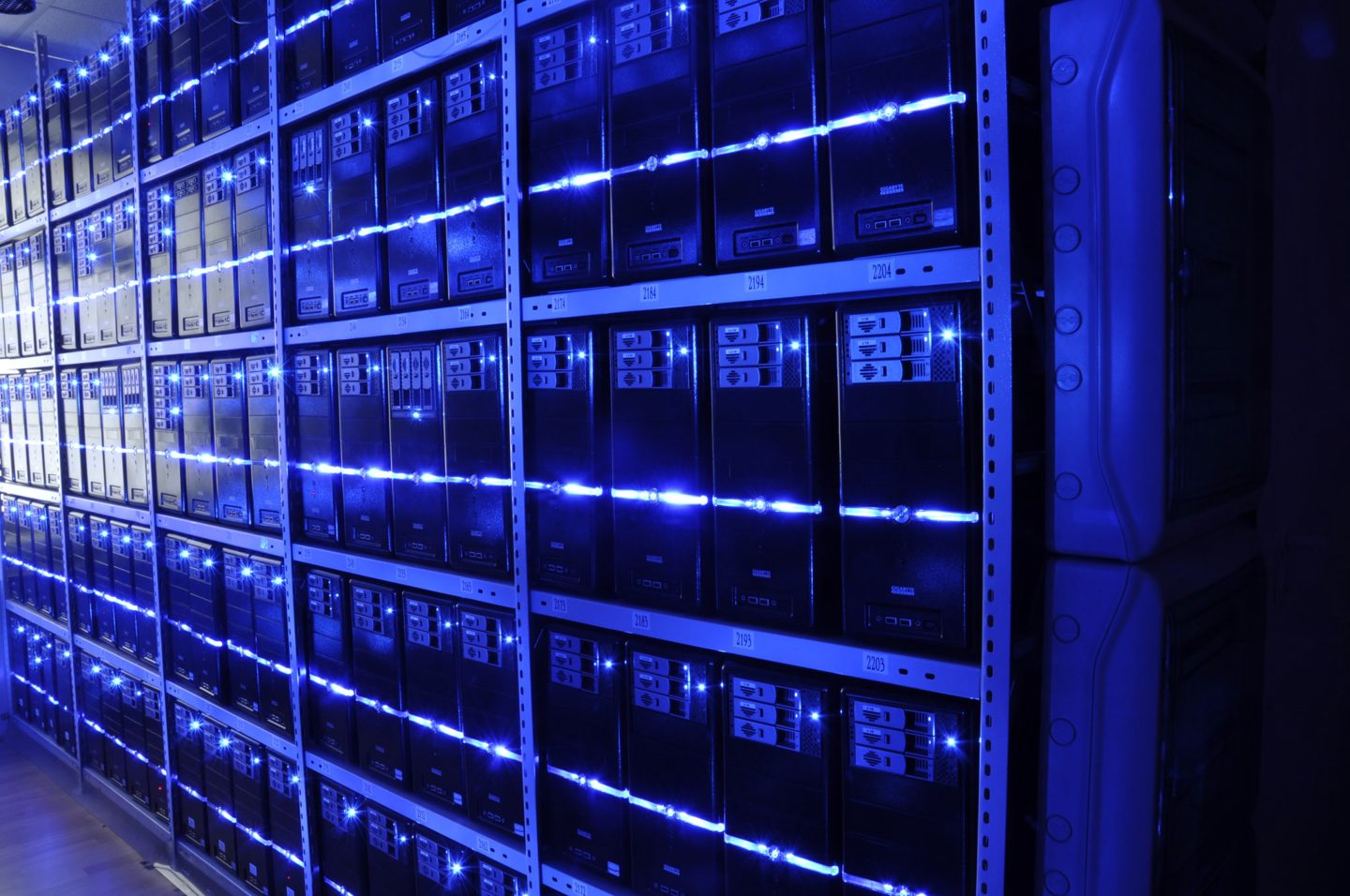 Rows of server racks inside a large data center hall