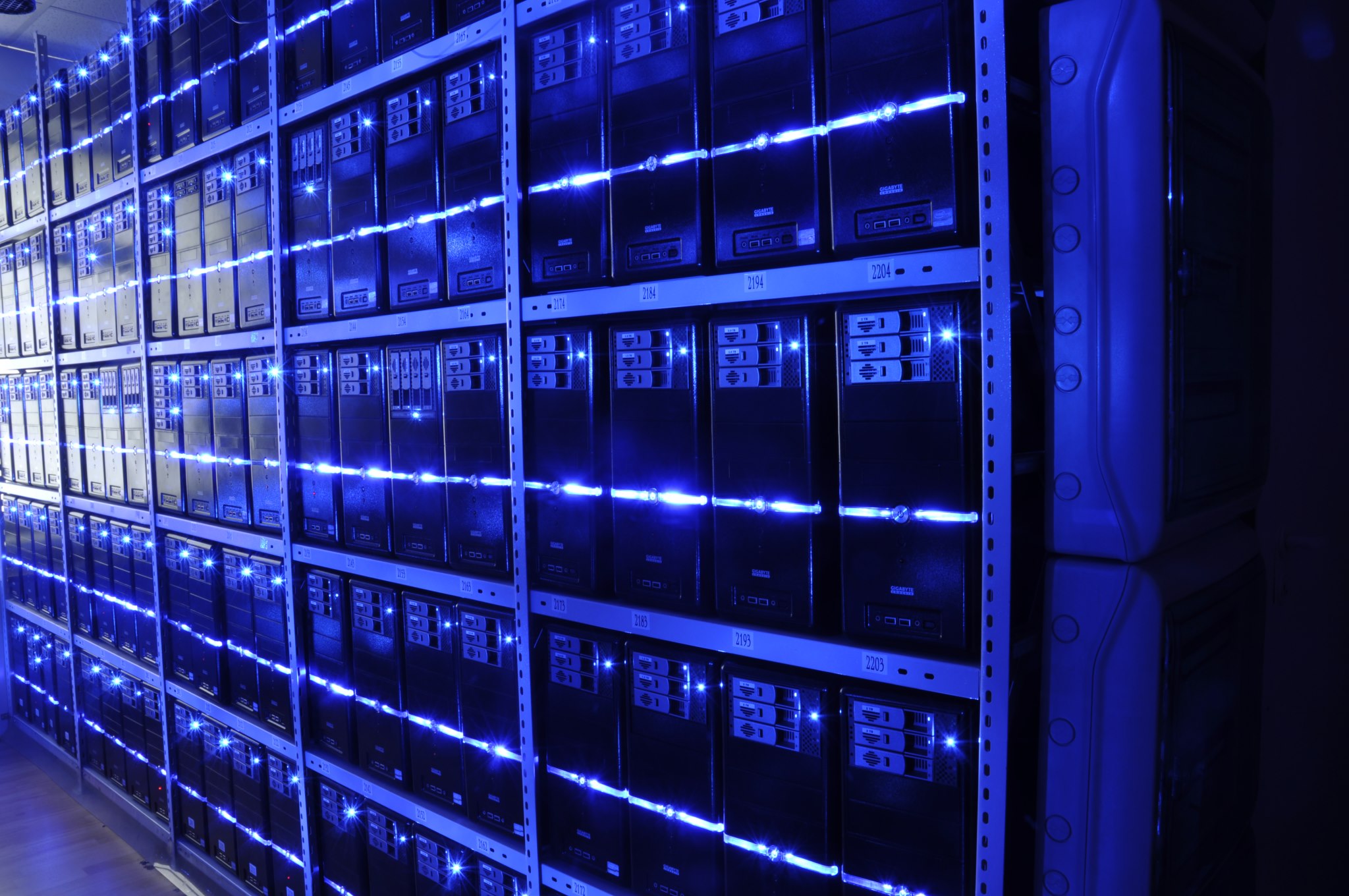 Rows of server racks inside a large data center hall